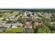 Wide aerial view of a neighborhood with tree-lined streets and a lake, highlighting community charm at 3271 Settlers Trl, St Cloud, FL 34772