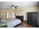 Comfortable bedroom featuring wood floors, ceiling fan and a walk-in closet at 3271 Settlers Trl, St Cloud, FL 34772
