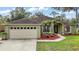 Charming single-story home with a well-maintained lawn, beautiful landscaping, and attached two-car garage at 3271 Settlers Trl, St Cloud, FL 34772