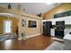 The kitchen features an eat-in kitchen, a sleek black refrigerator, stainless steel appliances, and hardwood floors at 3271 Settlers Trl, St Cloud, FL 34772