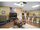 Open-concept living room features wood floors, lots of light, bar seating and easy kitchen access at 3271 Settlers Trl, St Cloud, FL 34772