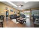 Bright living room features wood floors, vaulted ceilings, ceiling fan, and sliding doors to pool at 3271 Settlers Trl, St Cloud, FL 34772