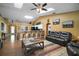 Open-concept living room features wood floors, vaulted ceilings, kitchen view, and easy kitchen access at 3271 Settlers Trl, St Cloud, FL 34772
