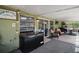 Covered patio area with ample seating and a black chest freezer at 3271 Settlers Trl, St Cloud, FL 34772
