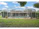 Screened-in pool with a bird bath surrounded by rocks and green foliage offering a relaxing outdoor retreat at 3271 Settlers Trl, St Cloud, FL 34772