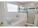 Bright bathroom showcasing a soaking tub, walk in shower, and window over tub at 331 Bridgewater Dr, Davenport, FL 33897