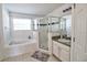 Bright bathroom with tiled floors, a soaking tub, walk in shower, and double sinks at 331 Bridgewater Dr, Davenport, FL 33897