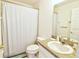 Practical bathroom featuring essential fixtures, a shower with neutral curtain, and tiled flooring at 331 Bridgewater Dr, Davenport, FL 33897