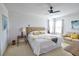 Bright bedroom featuring a ceiling fan, neutral walls, and a seating area with a sofa at 331 Bridgewater Dr, Davenport, FL 33897