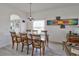 Formal dining room with modern decor, chandelier lighting, and ample seating at 331 Bridgewater Dr, Davenport, FL 33897