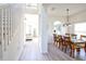 Bright dining area with wood table set for eight, chandelier, and neutral wall paint at 331 Bridgewater Dr, Davenport, FL 33897