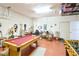 Spacious game room featuring a pool table, foosball, and seating area, perfect for entertaining at 331 Bridgewater Dr, Davenport, FL 33897