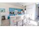 Kitchen with blue cabinets, laminate floors, white appliances, and a breakfast bar at 331 Bridgewater Dr, Davenport, FL 33897