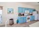 Kitchen with blue cabinets, laminate floors, and white appliances at 331 Bridgewater Dr, Davenport, FL 33897