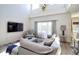 Well-lit living room with sliding glass doors, comfortable seating, and open layout to the kitchen at 331 Bridgewater Dr, Davenport, FL 33897