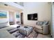 Open-concept living room with vaulted ceiling, modern furnishings, and large-screen television at 331 Bridgewater Dr, Davenport, FL 33897