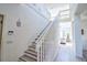 Bright, spacious foyer showcasing a staircase with white banister and access to the living room at 331 Bridgewater Dr, Davenport, FL 33897