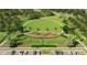 Aerial view of a fenced dog park with playground and green space surrounded by trees and parking at 3503 Kimbrough Dr, Lake Wales, FL 33859