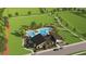 Aerial view of the community pool with ample seating, lush landscaping, and modern building at 3503 Kimbrough Dr, Lake Wales, FL 33859