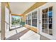 Covered balcony with exterior view, seating, and a white door leading indoors at 3757 Conroy Rd # 2525, Orlando, FL 32839