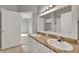 Bright bathroom featuring double sinks with granite counters and a large mirror at 3757 Conroy Rd # 2525, Orlando, FL 32839