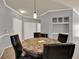 Dining area featuring a round table with four chairs, pendant lighting, and neutral wall color at 3757 Conroy Rd # 2525, Orlando, FL 32839