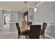 Dining area with a round table, four chairs, pendant lighting, and views into kitchen and living areas at 3757 Conroy Rd # 2525, Orlando, FL 32839