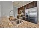 Kitchen featuring a stainless steel sink, granite countertops, tiled backsplash, and modern appliances at 3757 Conroy Rd # 2525, Orlando, FL 32839