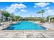 Resort-style pool with ample lounge chairs and lush landscaping under sunny skies at 3757 Conroy Rd # 2525, Orlando, FL 32839