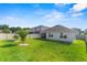 Expansive backyard featuring a well-manicured lawn, trees, and a white privacy fence at 3817 Heartleaf Ln, Mount Dora, FL 32757