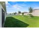 Lush green backyard with a white fence and mature trees for privacy and shade at 3817 Heartleaf Ln, Mount Dora, FL 32757