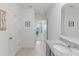 Modern bathroom with granite countertops, a bright window, and access to an adjacent bedroom at 3817 Heartleaf Ln, Mount Dora, FL 32757