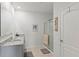 Clean bathroom featuring a granite countertop, walk-in shower, and neutral decor at 3817 Heartleaf Ln, Mount Dora, FL 32757