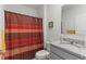 Bathroom with granite countertop, vanity, toilet, and shower with curtain at 3817 Heartleaf Ln, Mount Dora, FL 32757