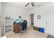 Bedroom featuring a desk, computer, and shelving unit, ideal for a home office at 3817 Heartleaf Ln, Mount Dora, FL 32757