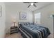 Comfortable bedroom features a ceiling fan, window, and stylish bedside table with a lamp at 3817 Heartleaf Ln, Mount Dora, FL 32757