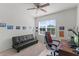 Bright bedroom with a window, sofa, and desk area, perfect for relaxation and productivity at 3817 Heartleaf Ln, Mount Dora, FL 32757