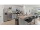 Open kitchen with granite counters, stainless appliances, and a large island with bar seating at 3817 Heartleaf Ln, Mount Dora, FL 32757