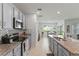 Modern kitchen featuring sleek gray cabinets, granite countertops, and stainless steel appliances at 3817 Heartleaf Ln, Mount Dora, FL 32757