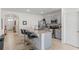 Spacious kitchen with gray cabinets, granite island, and stainless appliances is open and inviting at 3817 Heartleaf Ln, Mount Dora, FL 32757