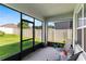 Enclosed lanai offering a peaceful view of the fenced backyard at 3817 Heartleaf Ln, Mount Dora, FL 32757