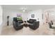 Bright living room featuring tile floors, a ceiling fan, contemporary furniture, and an open layout at 3817 Heartleaf Ln, Mount Dora, FL 32757