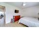 Well-lit bedroom features a chest of drawers, TV, and view into an office area at 4438 Pinebark Ave # 4, Orlando, FL 32811