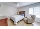 Cozy bedroom featuring a wood headboard, comfy recliner, and warm, inviting décor at 4438 Pinebark Ave # 4, Orlando, FL 32811