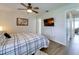 Cozy bedroom featuring wood floors, ceiling fan, and a wall-mounted television for comfortable relaxation at 4438 Pinebark Ave # 4, Orlando, FL 32811