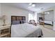 Bedroom with wood headboard, comfy chair, mirrored closet doors and hardwood floors at 4438 Pinebark Ave # 4, Orlando, FL 32811
