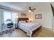 Primary bedroom with wood floors, ceiling fan, and desk with natural light at 4438 Pinebark Ave # 4, Orlando, FL 32811