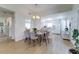 Bright dining area with light wood floors, a glass table, and views into the kitchen, creating an open and inviting living space at 4438 Pinebark Ave # 4, Orlando, FL 32811