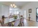 Inviting dining area with glass table opens to the modern white kitchen at 4438 Pinebark Ave # 4, Orlando, FL 32811