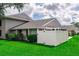 A beautifully maintained property featuring a white fence, fresh greenery, and a well-manicured lawn, creating a welcoming outdoor space at 4438 Pinebark Ave # 4, Orlando, FL 32811